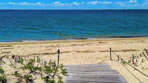 A wooden boardwalk leading to a sandy beach with a clear view of the ocean. - Peaceful Beachfront Cottage with Bay Views: near town, bike trails & dune walks (North Truro)