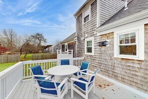 Outdoor dining - Cozy coastal home close to the bay with large deck, fenced yard, AC & beach gear (West Yarmouth)