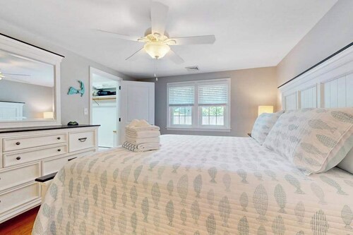Charming coastal home near pond with sunroom, open layout, yard & AC