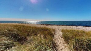 A beach path leading to the sea with clear skies. - Cozy cottage steps to the beach with patio, W/D, & partial AC (North Truro)
