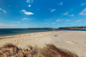 A beach with clear skies, calm water, and distant land. - North Falmouth House: Near Beach, Fire Pit, & Dog-Friendly! (North Falmouth)
