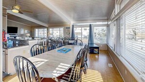 A spacious dining area with a large table, chairs, and a ceiling fan. - Lovely home with private pool, hot tub, foosball, air hockey & easy beach access (Virginia Beach)