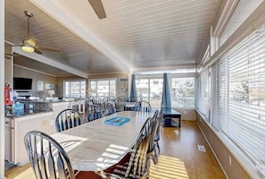 A spacious dining area with a large table, chairs, and a ceiling fan. - Lovely home with private pool, hot tub, foosball, air hockey & easy beach access (Virginia Beach)