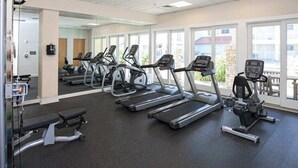 A gym with treadmills, ellipticals, and weight machines. - Courtyard condo near the ocean with W/D, outdoor pool & gym (Virginia Beach)