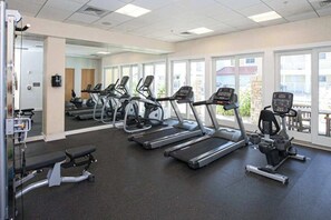 A gym with treadmills, ellipticals, and weight machines. - Courtyard condo near the ocean with W/D, outdoor pool & gym (Virginia Beach)