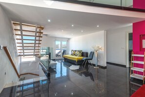 A modern interior with a staircase, a sofa, a coffee table, and a view to the outside. - Ivy 2 - apartment with sea view for up to 8 people (Okrug Gornji)
