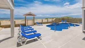 A pool area with lounge chairs, a hot tub, and a view of the beach. - Wonderful beachfront home w/private indoor & outdoor pools, WiFi, AC, deck (Virginia Beach)