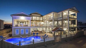 A multi-story house with a pool, outdoor seating, and a deck. - Wonderful beachfront home w/private indoor & outdoor pools, WiFi, AC, deck (Virginia Beach)