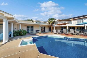 A swimming pool with lounge chairs and a covered patio area. - 8 BDR & 7.5 BA Luxury Beach House w/private pool & hot tub (Virginia Beach)