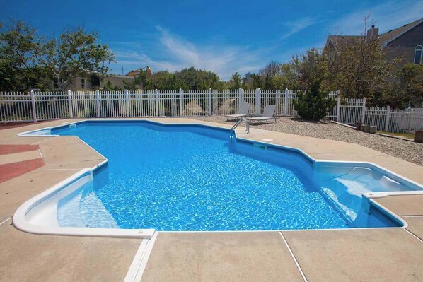A rectangular swimming pool with a white fence surrounding it. - 8 BDR & 7.5 BA Luxury Beach House w/private pool & hot tub (Virginia Beach)