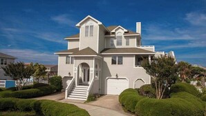 A two-story house with a front porch, a staircase, and a garage.