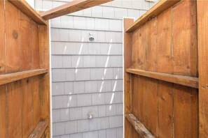 A wooden structure with a gray shingled wall, a metal door, and a small window. - Canal-front home w/private pool, hot tub, fishing dock, walk to the beach,2 dogs (Virginia Beach)