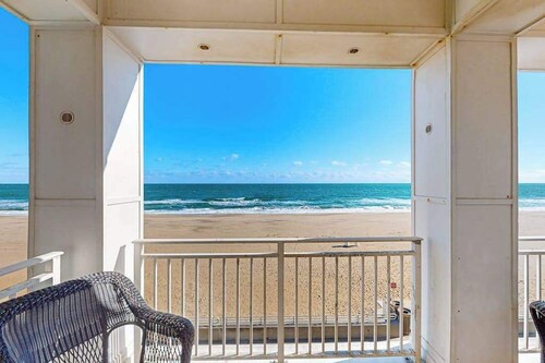 Beachfront 2nd-floor condo with ocean views, balcony, 3 pools & gym