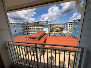 A hotel with multiple floors, a parking area, and a view of the surrounding buildings. - Your Perfect Family Beach Escape – Steps to the Sand with Resort-Style Amenities (Virginia Beach)