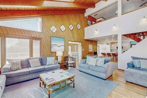 A spacious living area with two sofas, a coffee table, and a dining table. - Lovely, contemporary home w/private pool/hot tub, easy beach access, central AC (Virginia Beach)