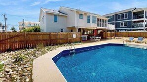 A residential property with a swimming pool, a wooden deck, and a fenced backyard. - Well-Appointed Home w/Private Outdoor Pool, Gas Grill, Washer/Dryer, A/C (Virginia Beach)