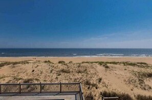 A beach view with a wooden deck and dunes. - Oceanfront home with private pool, crow's nest deck, game room & fireplace (Virginia Beach)