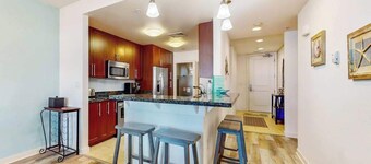 Sunlit single-level condo with pool, washer/dryer, central AC, & balcony