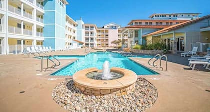 Sunlit single-level condo with pool, washer/dryer, central AC, & balcony