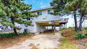 A two-story house with a covered porch and a wooden deck. - Oceanfront home w/private pool, beautiful views, WiFi, central AC, private W/D (Virginia Beach)