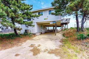 A two-story house with a covered porch and a wooden deck. - Oceanfront home w/private pool, beautiful views, WiFi, central AC, private W/D (Virginia Beach)