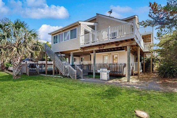 A two-story house with a balcony, a staircase, and a small outdoor seating area. - 3-story home w/great views of ocean, fenced private pool, and easy beach access (Virginia Beach)
