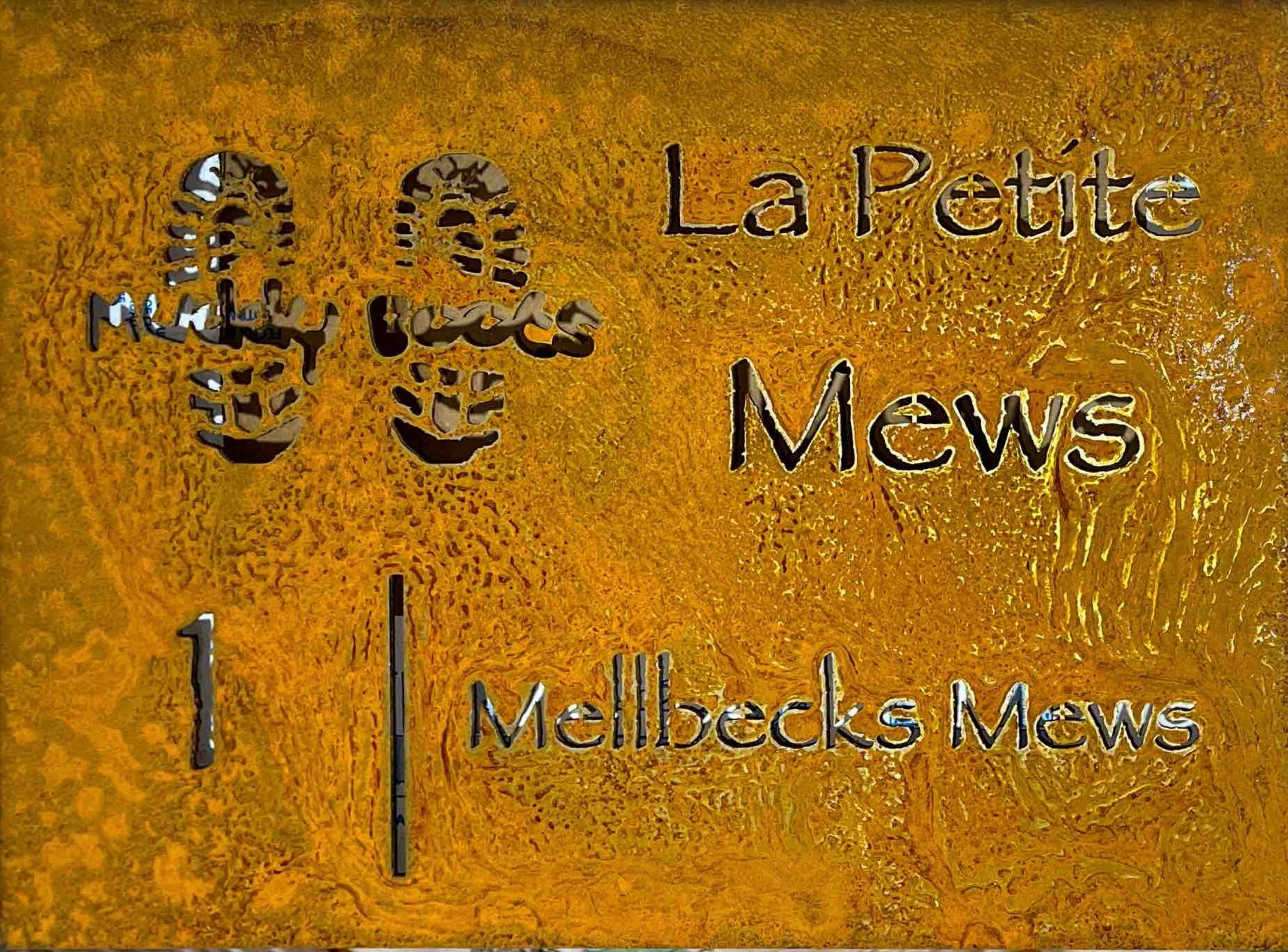 A textured surface with embossed text 'La Petite Mews' and 'Mellbecks Mews.'