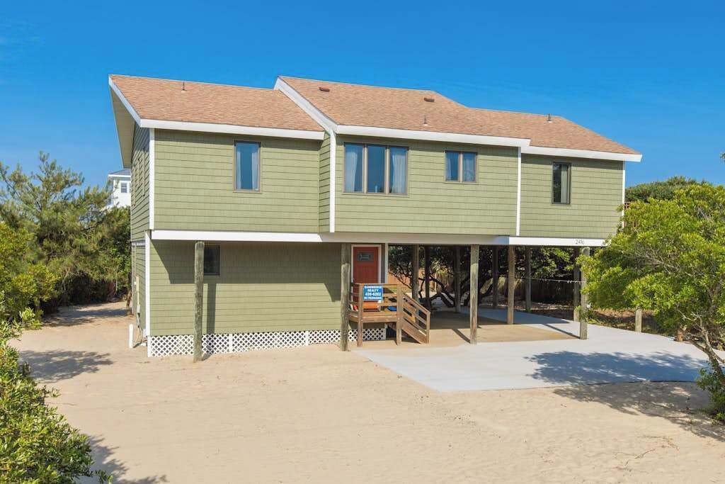 A two-story house with a covered porch and a front door.