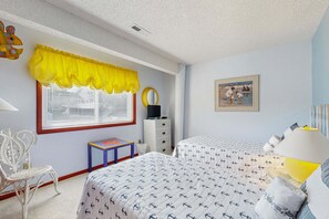 A bedroom with two beds, a window with blinds, a chair, a dresser, and a painting on the wall. - Bright and comfortable home steps from beach w/private pool, WiFi, & central AC (Virginia Beach)