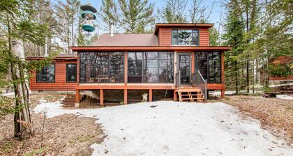 Riverfront vacation home with a dock, wood stove, full kitchen, & firepit