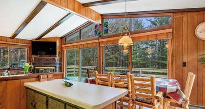 Lakefront Home with a Private Dock, Deck, Fireplace, Spacious Yard, & Playset