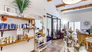 A spa with shelves of products, a reception area, and a view of the outside. - Wisconsin Dells Escape | Adventure Perks Included (Wisconsin Dells)