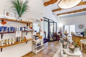 A spa with shelves of products, a reception area, and a view of the outside. - Wisconsin Dells Escape | Adventure Perks Included (Wisconsin Dells)