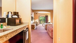 A hotel room with a kitchenette, a bed, a desk, and a view of the outdoors. - Family Friendly Chula Vista Studio/Discount Perks (Wisconsin Dells)