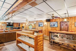 Eine Bar mit Holzwänden, einer Theke und einer Gläserauslage.
