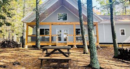 Dog-friendly, lakefront getaway with a firepit, dock, washer/dryer, & AC