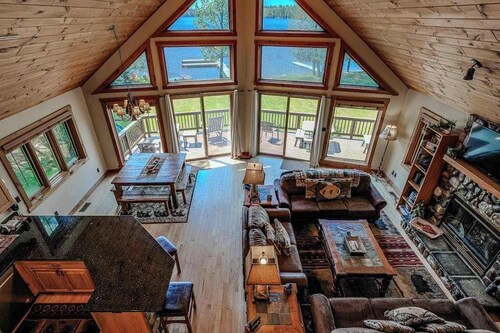 Lakefront lodge with private dock, firepit, deck & sunset views