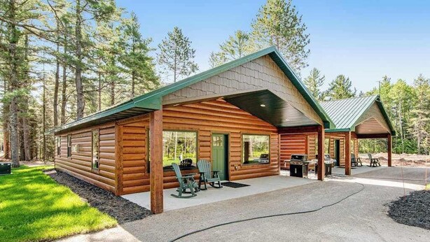 A log cabin with a covered porch, outdoor seating, and a grill area. - Dog-friendly cabin with hot tub, fireplace, patio, grill, central AC, & W/D (Conover)