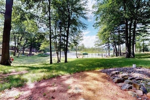 A park with a dirt path, trees, and a body of water in the background. - Lakefront home with large patio, fire pit, W/D & WIFI (Woodruff)