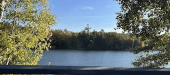 Gorgeous lakefront home with dock, sandy beach area, fireplace, huge deck & WIFI