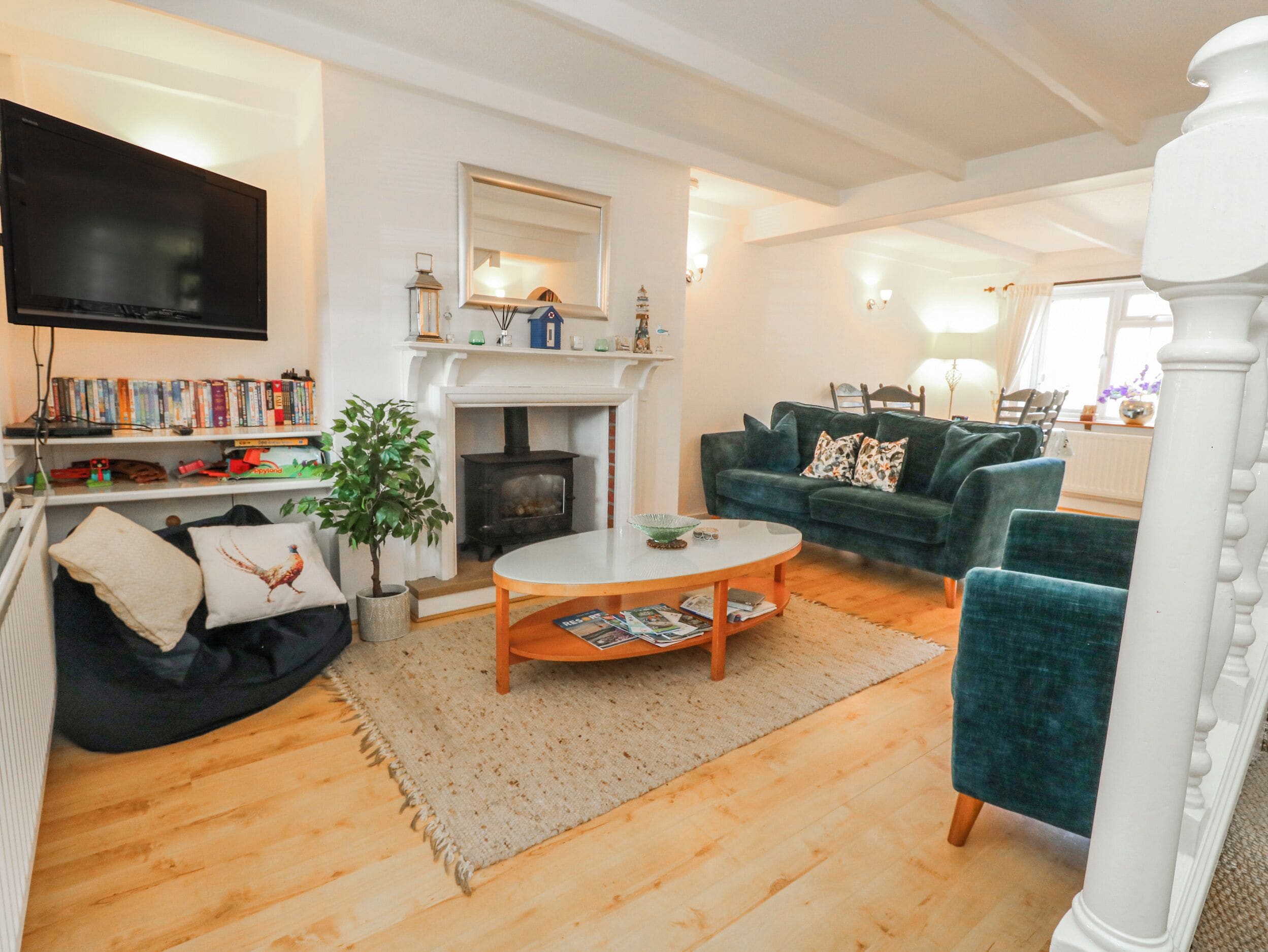 A living room with a fireplace, a television, a sofa, and a coffee table.