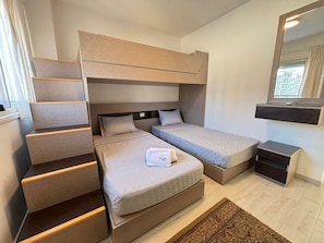A compact hotel room with bunk beds, a small desk, and a mirror. - Fouka North Coast CL4-Ch34-03 (El Dabaa)