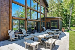 Outdoor dining - Luxury lakefront home with high-speed WiFi, dock, private beach, & theater room (Eagle River)