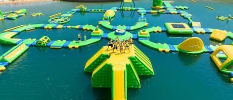 An aerial view of a water park with various inflatable play structures.