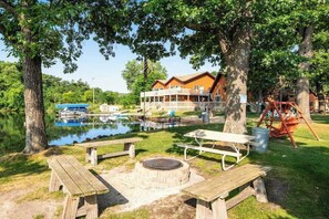 Outdoor dining - Lakefront condo with beach access, firepit, games, fireplace, & dock (Wisconsin Dells)