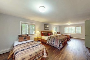A bedroom with three beds, large windows, and a ceiling light. - Charming Lakeview cabin w/ dock, fire pit, gas grill, & WIFI, Dogs-YES (St. Germain)