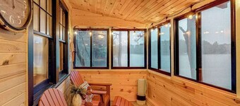 Lakeside cabin with a firepit, sunroom, & seasonal dock