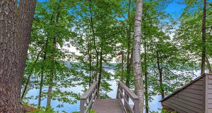 Snowy lake-view cabin with fireplace, full kitchen, TV, dock, & DVD player