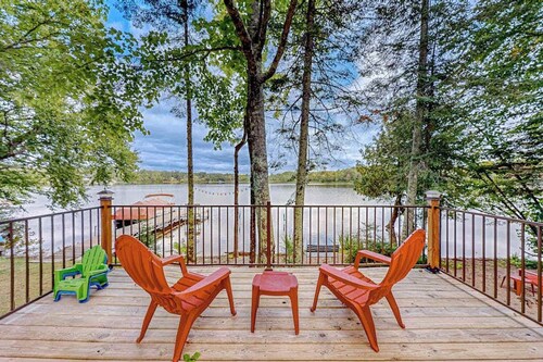 Dog-friendly lakefront home with a private beach, dock, firepit, & kayaks