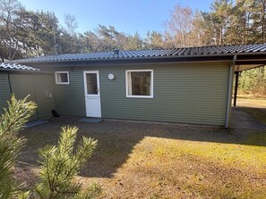 A single-story building with a door, two windows, and a covered porch area. - 5 Person Holiday Home in Aakirkeby (Akirkeby)